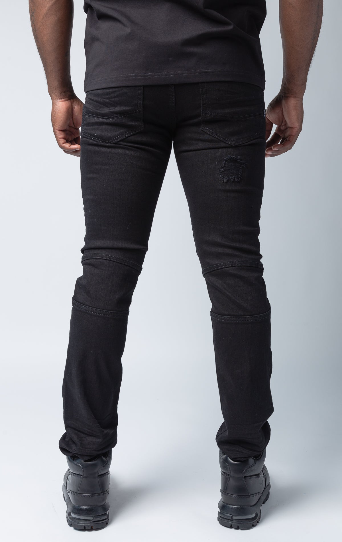 Black pants with rip and repair design and slim fit