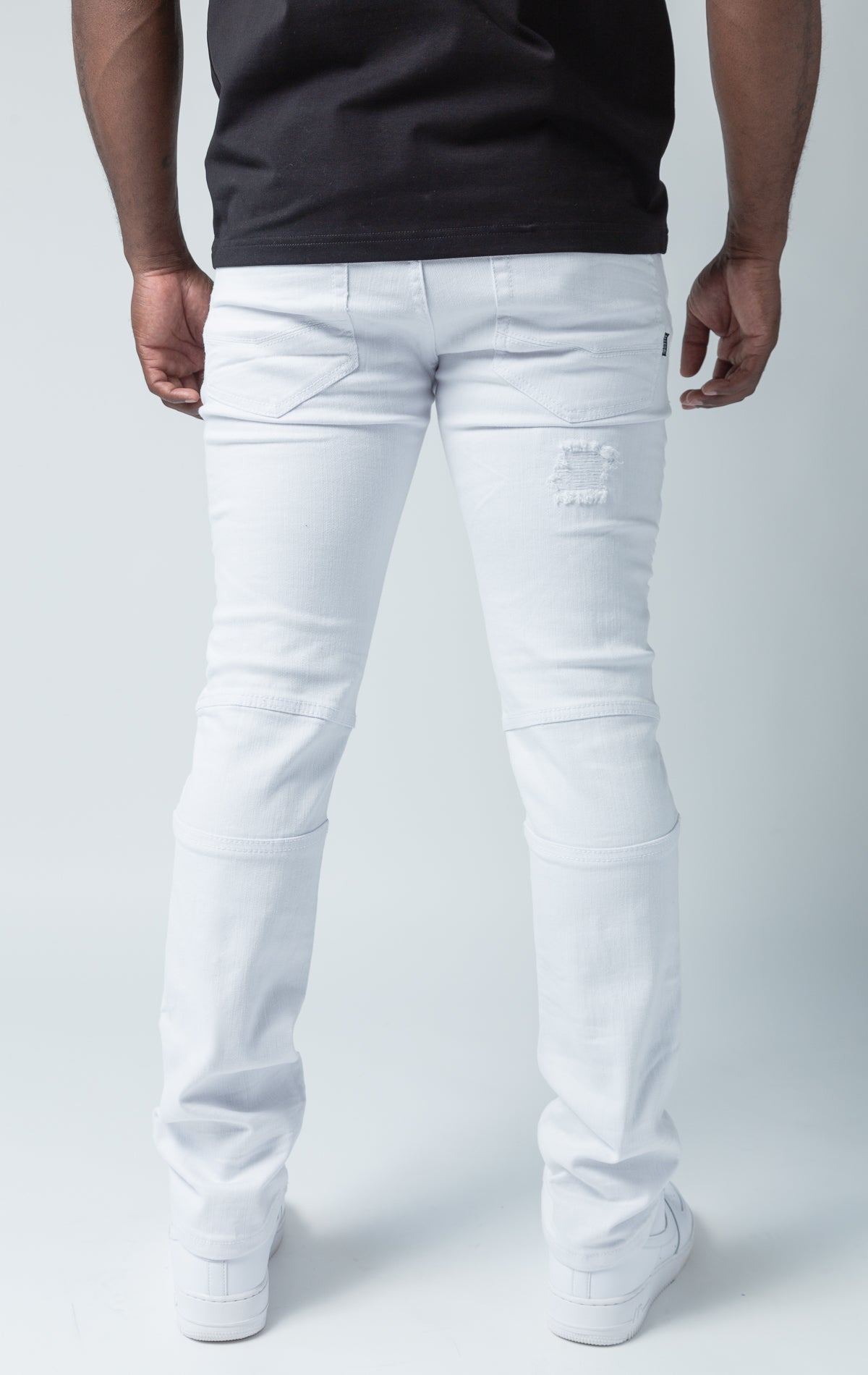 White pants with rip and repair design and slim fit