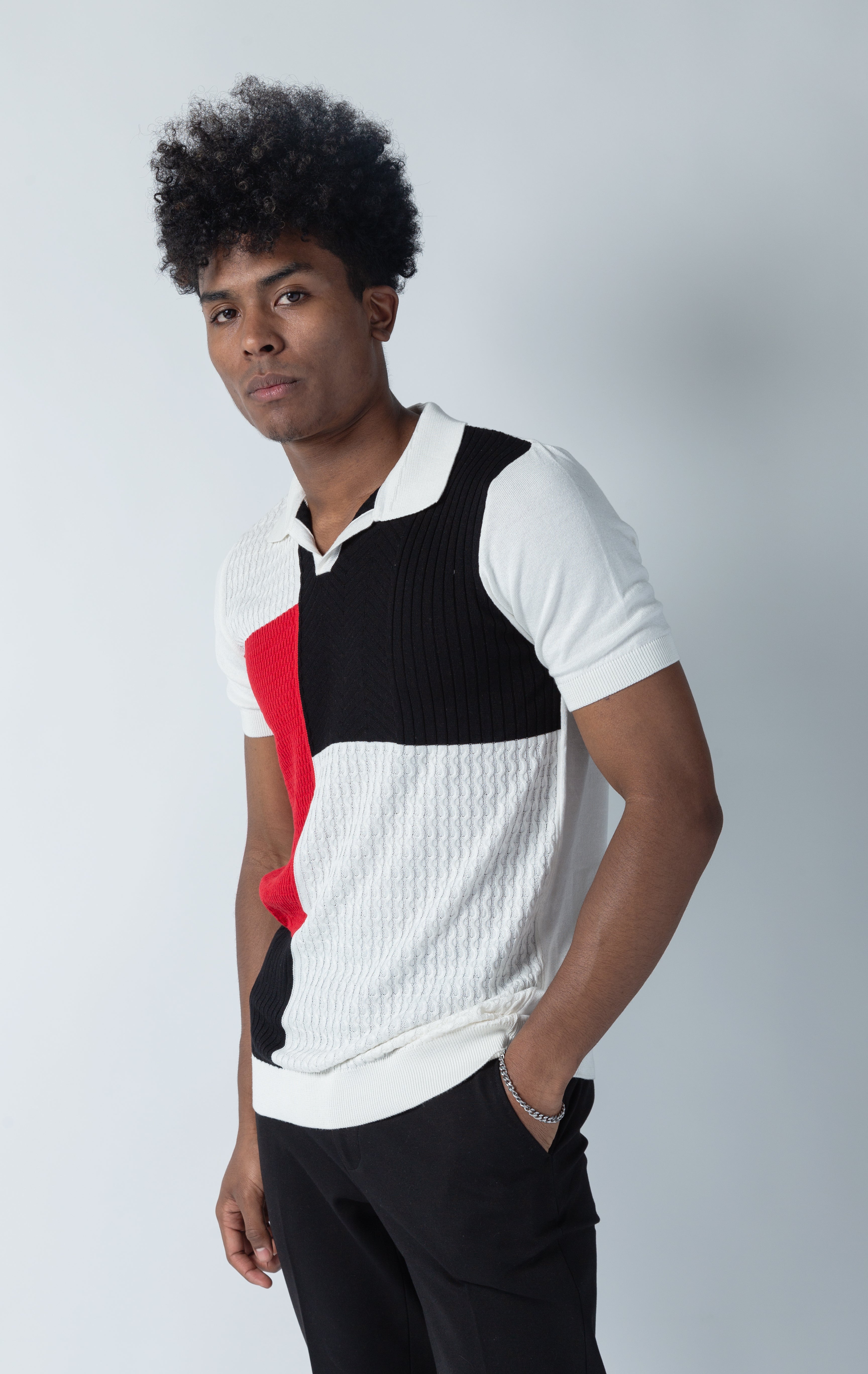White v-neck polo shirt with a meticulously detailed button placket for an exclusive, stylish look.