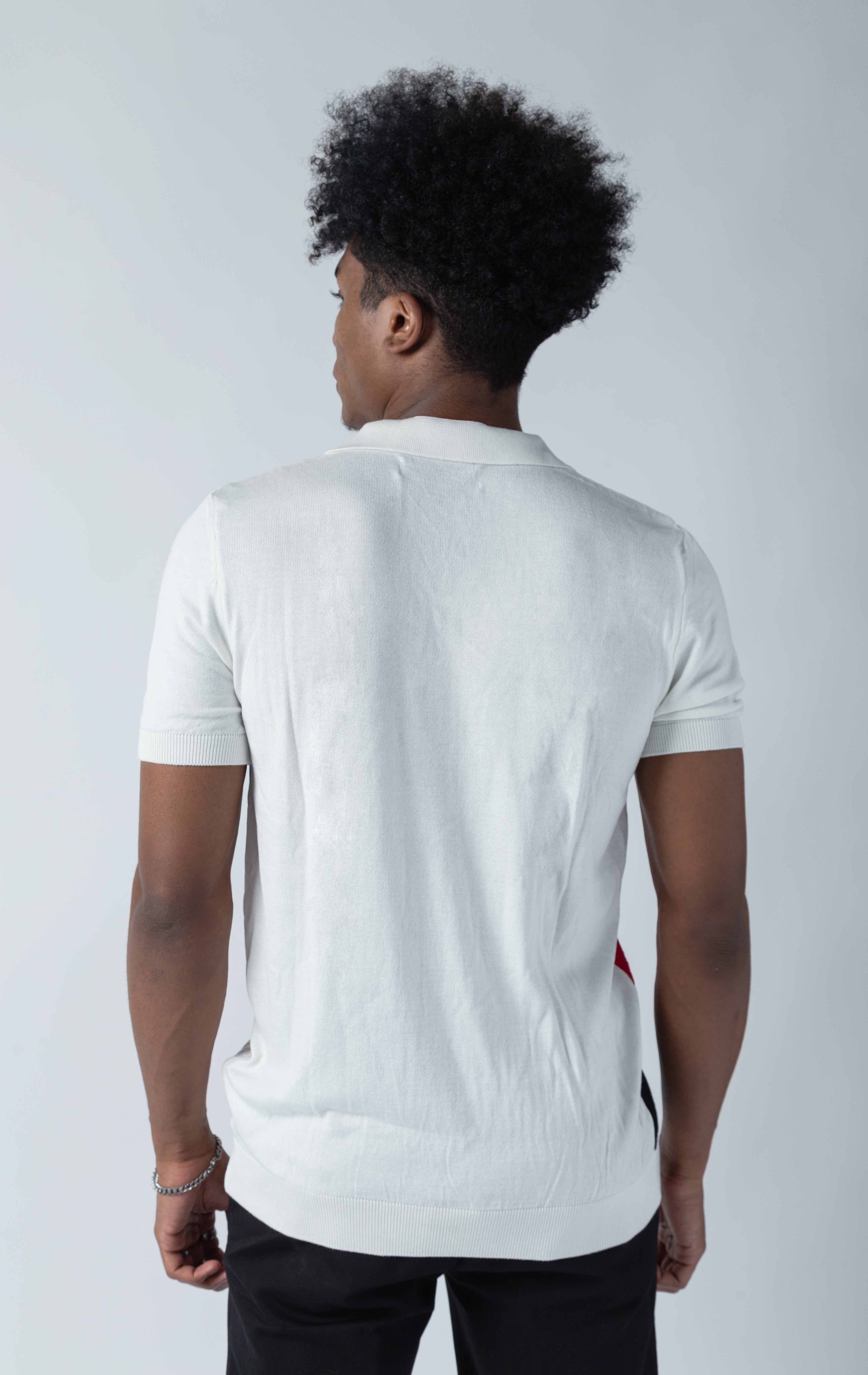 White v-neck polo shirt with a meticulously detailed button placket for an exclusive, stylish look.