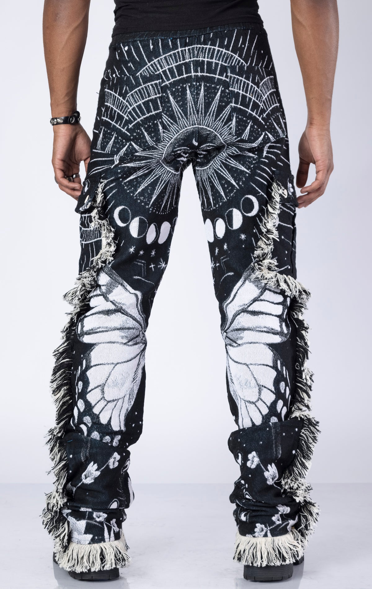 Obsidian Black Tapestry Pants. Made from 100% luxury cotton for superior comfort. Features a straight leg fit, allover tapestry print, cargo pockets, fringe accents, and custom hardware.