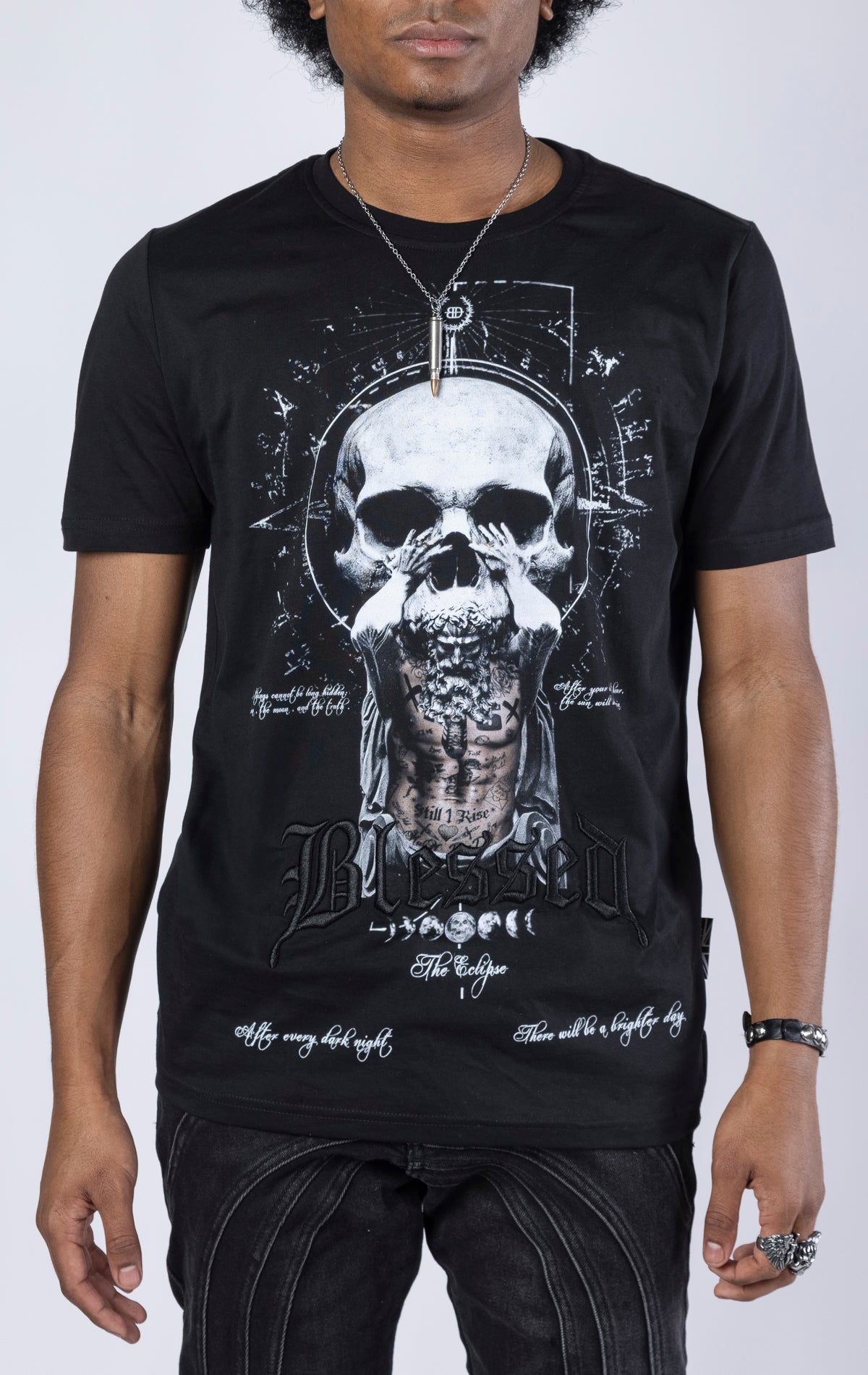 Blessed Eclipse Crewneck Tee. Features a soft-touch digital eclipse print, 3D embroidered "blessed" detail, and a woven "blessed" tab. Made from 100% 190gsm mid-weight cotton jersey.