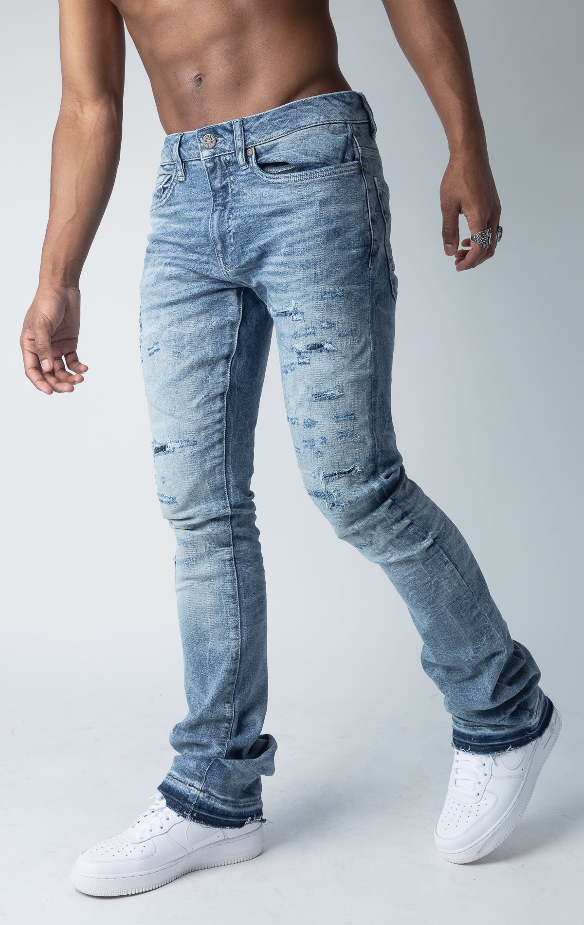 True blue jeans with 3D wrinkles, rip and repair design