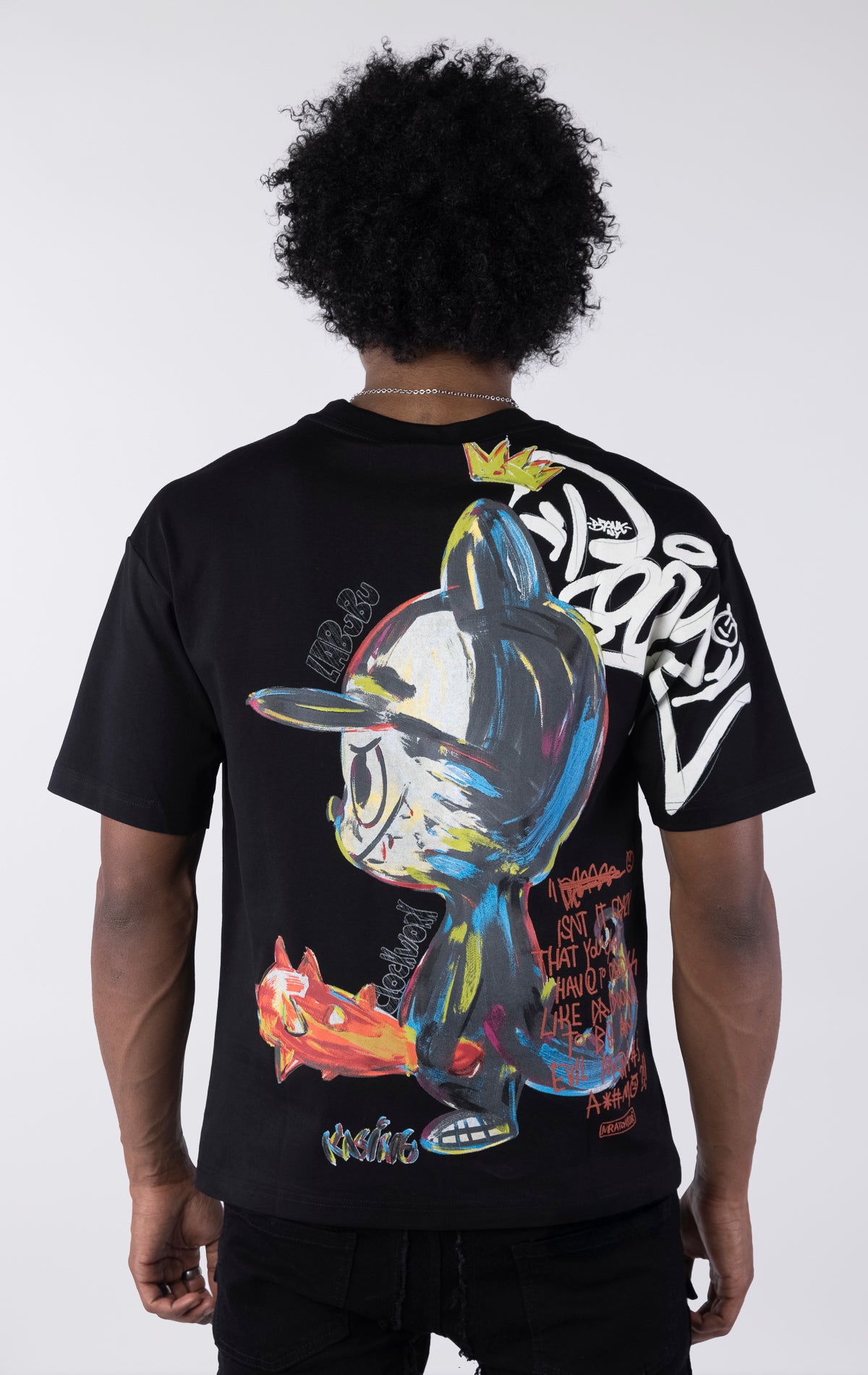 Person wearing a black t-shirt with colorful graphic design on the back against a white background