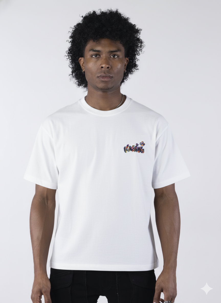 White short-sleeve t-shirt showing the back, featuring a large, colorful, graffiti-style illustration of a cartoon character in a backwards cap and crown. The text "Bubu" and other tags surround the central image.