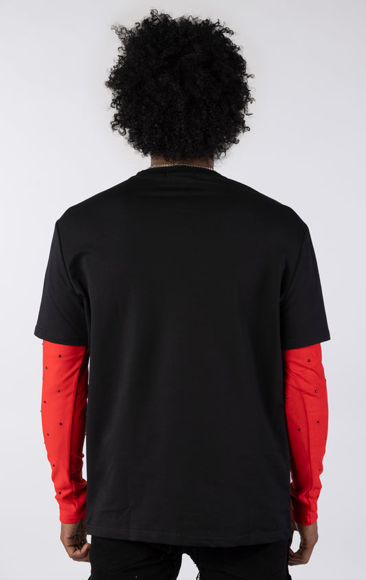 Person wearing a black t-shirt with red sleeves on a white background