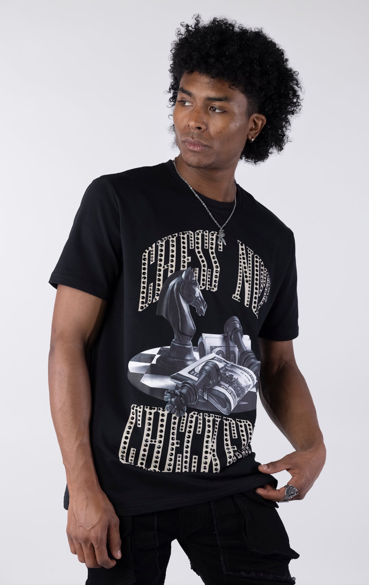 Person wearing a black t-shirt with graphic design on a white background