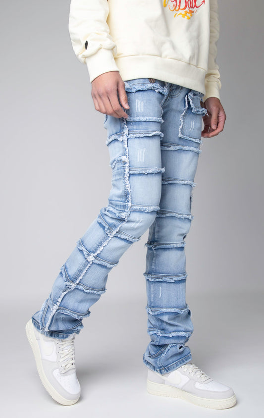 ice blue Stacked denim pants, distressed and paneled with a raw finishing