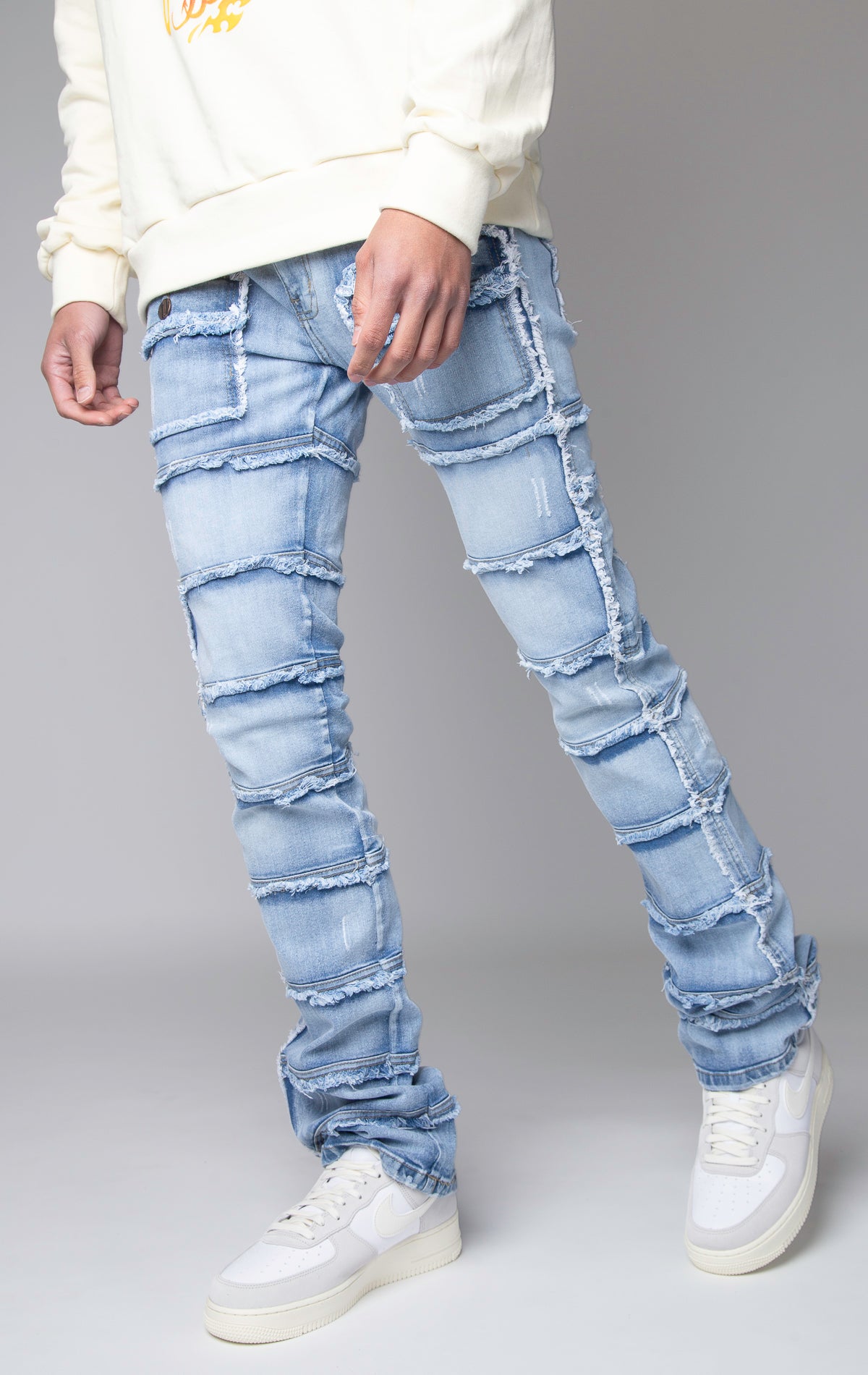 ice blue Stacked denim pants, distressed and paneled with a raw finishing