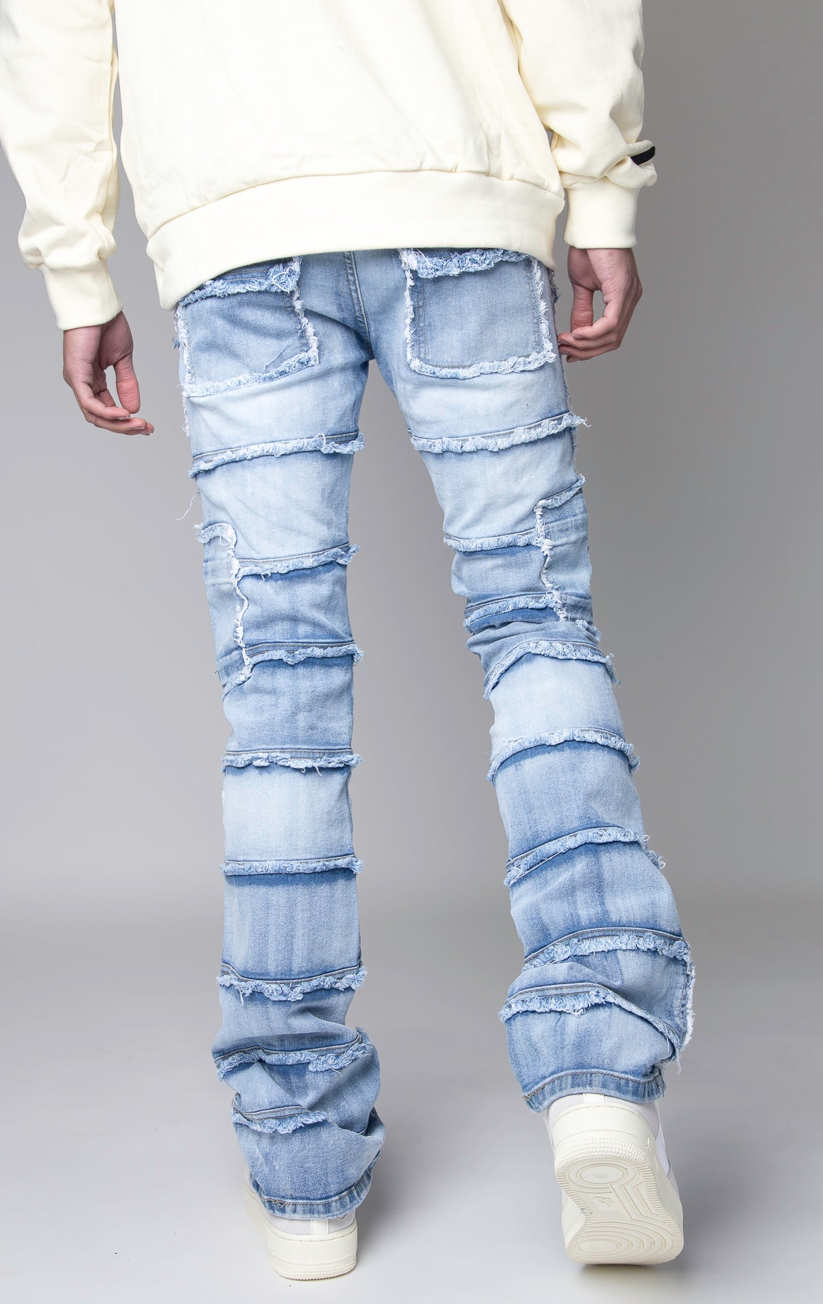 ice blue Stacked denim pants, distressed and paneled with a raw finishing