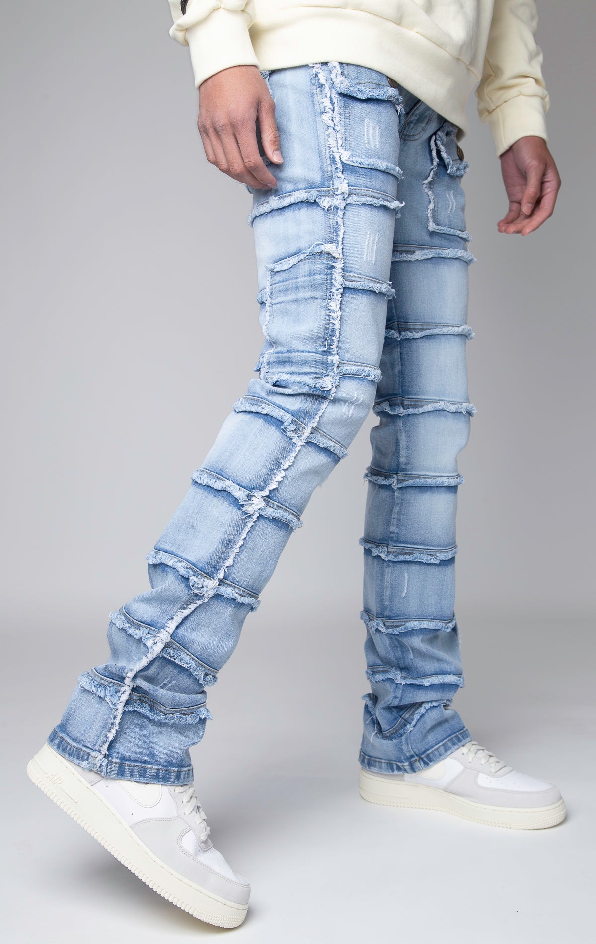 ice blue Stacked denim pants, distressed and paneled with a raw finishing