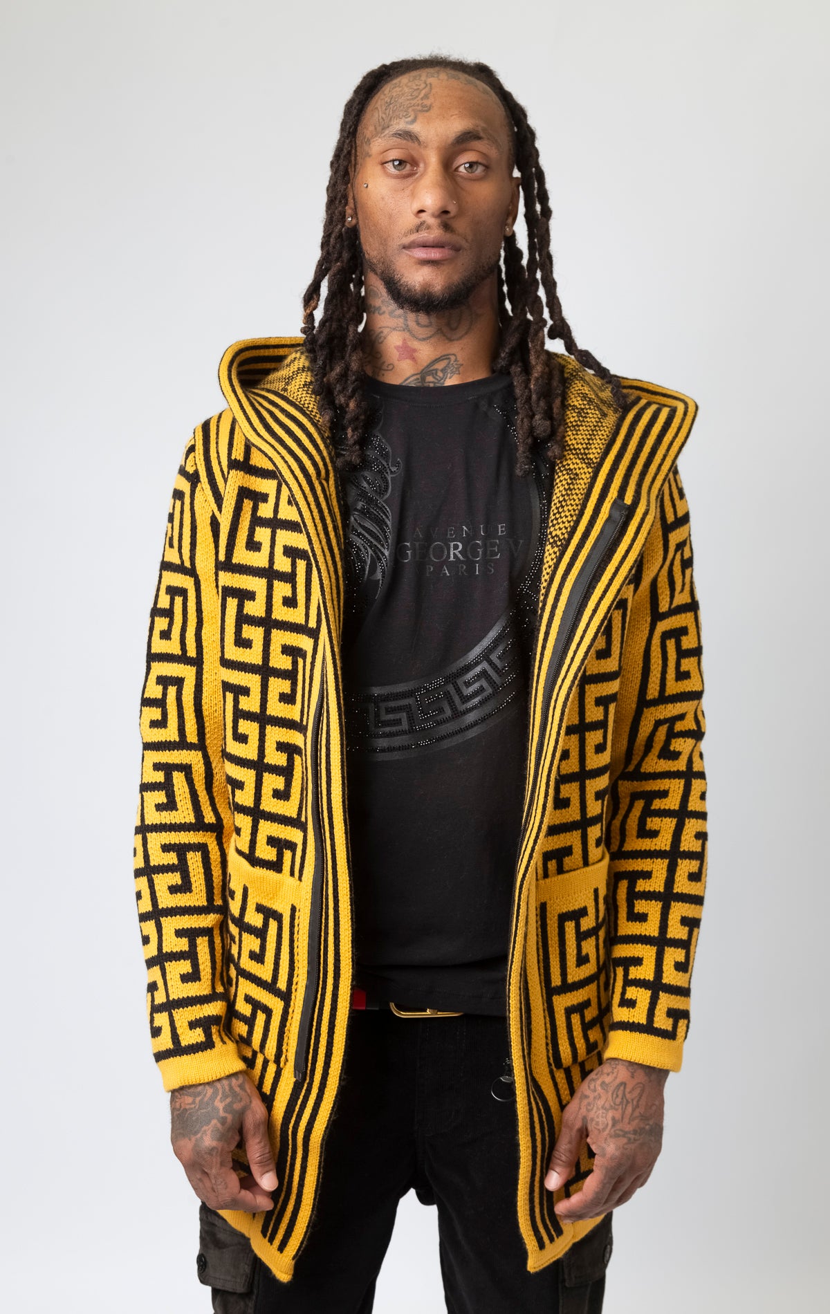 Mustard colored cardigan with a hood, front pocket, and pattern design.
