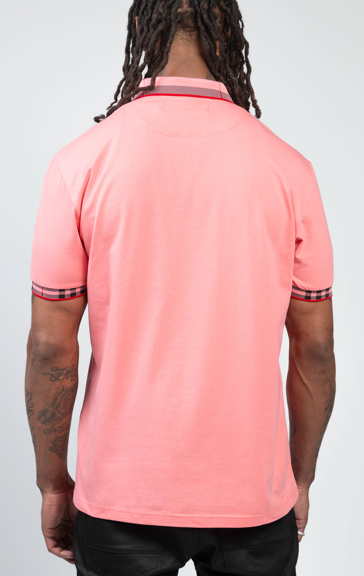 Short-sleeved polo shirt in vibrant coral color, featuring a modern front zipper.