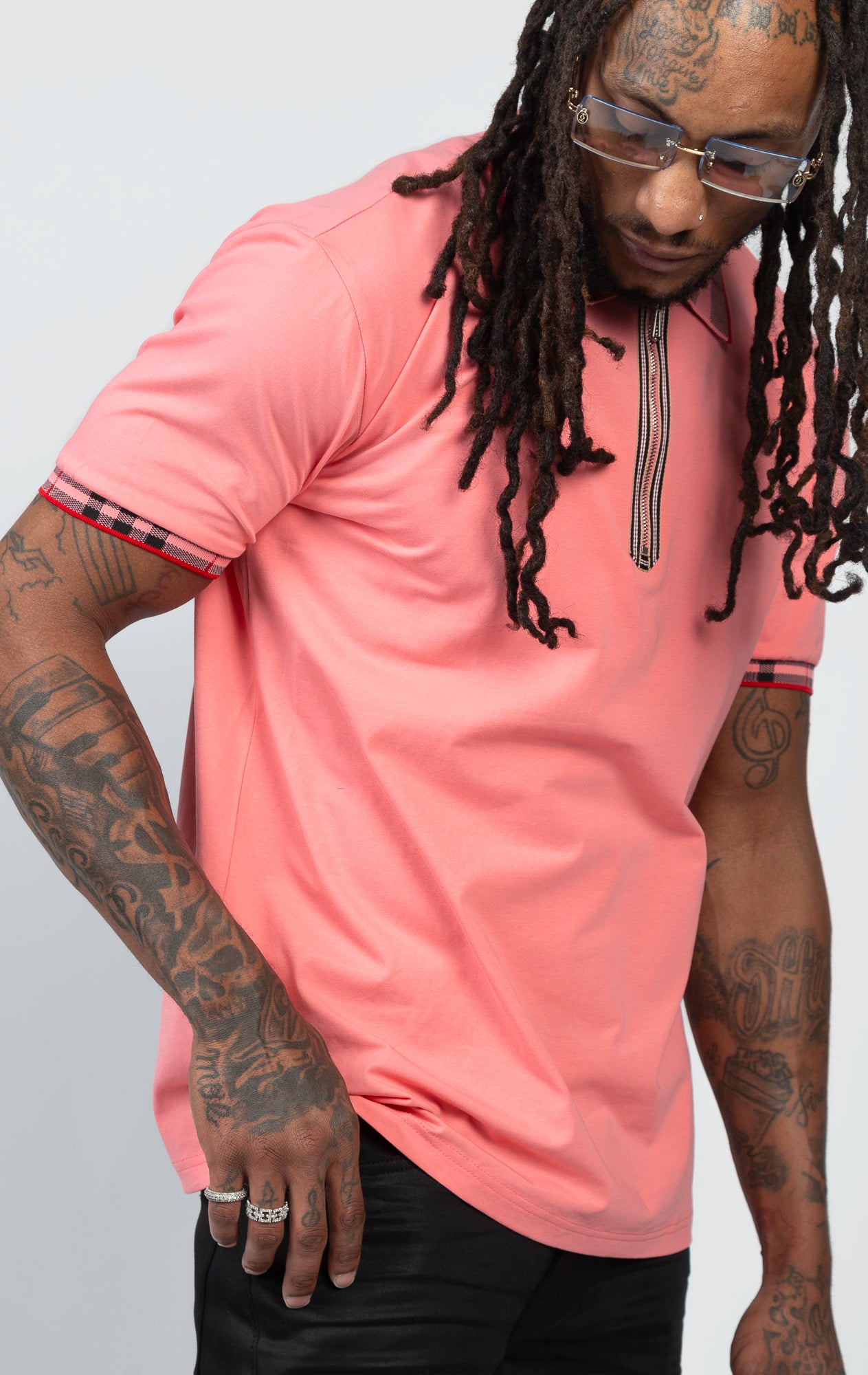 Short-sleeved polo shirt in vibrant coral color, featuring a modern front zipper.