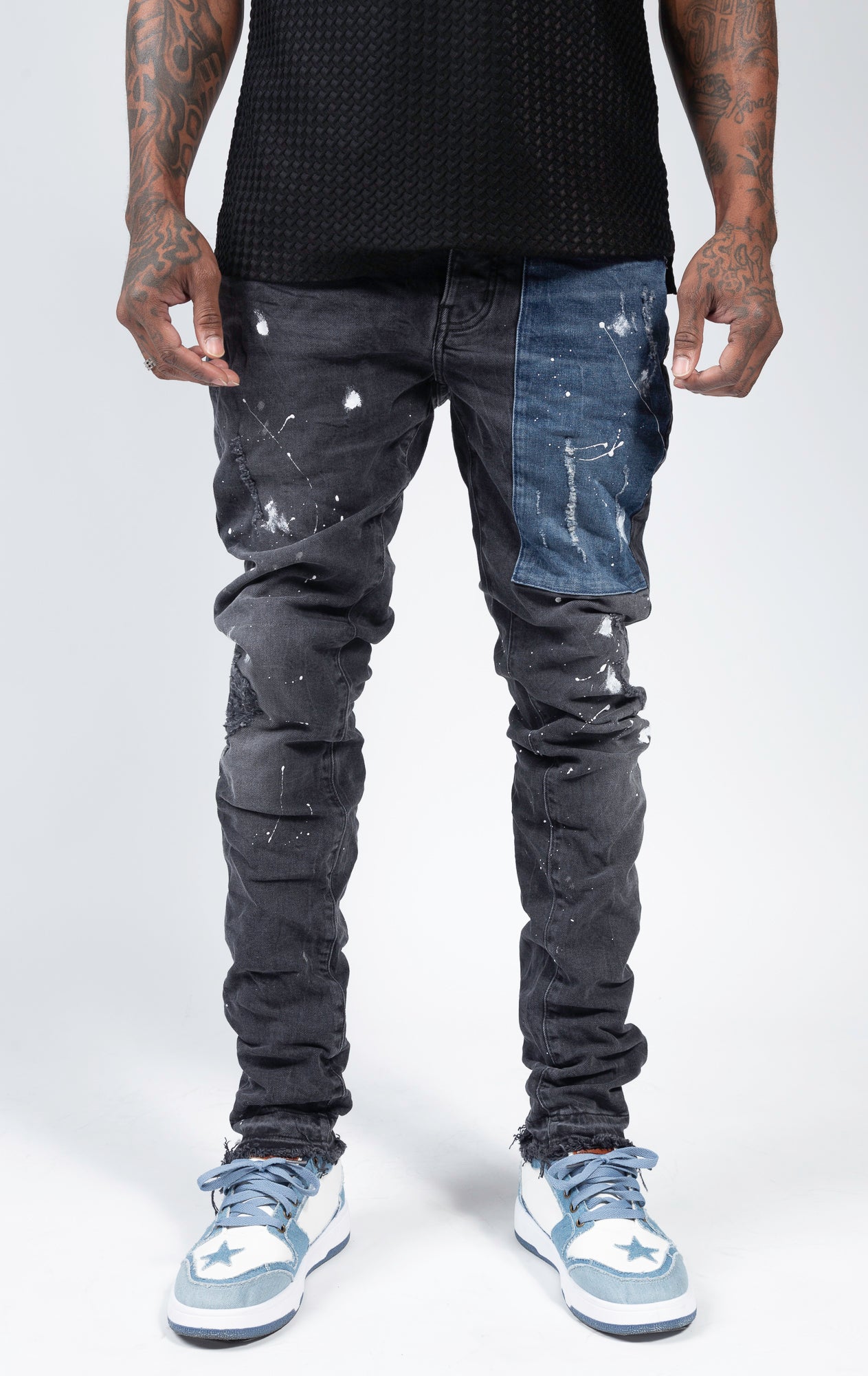 Ripped patchwork jeans with paint splatters