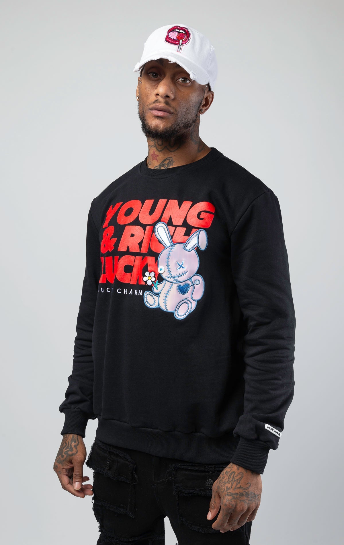 Black stylish and comfortable sweatshirt featuring a vibrant lucky charm bunny print and an empowering 'Young, Rich, and Lucky' slogan.