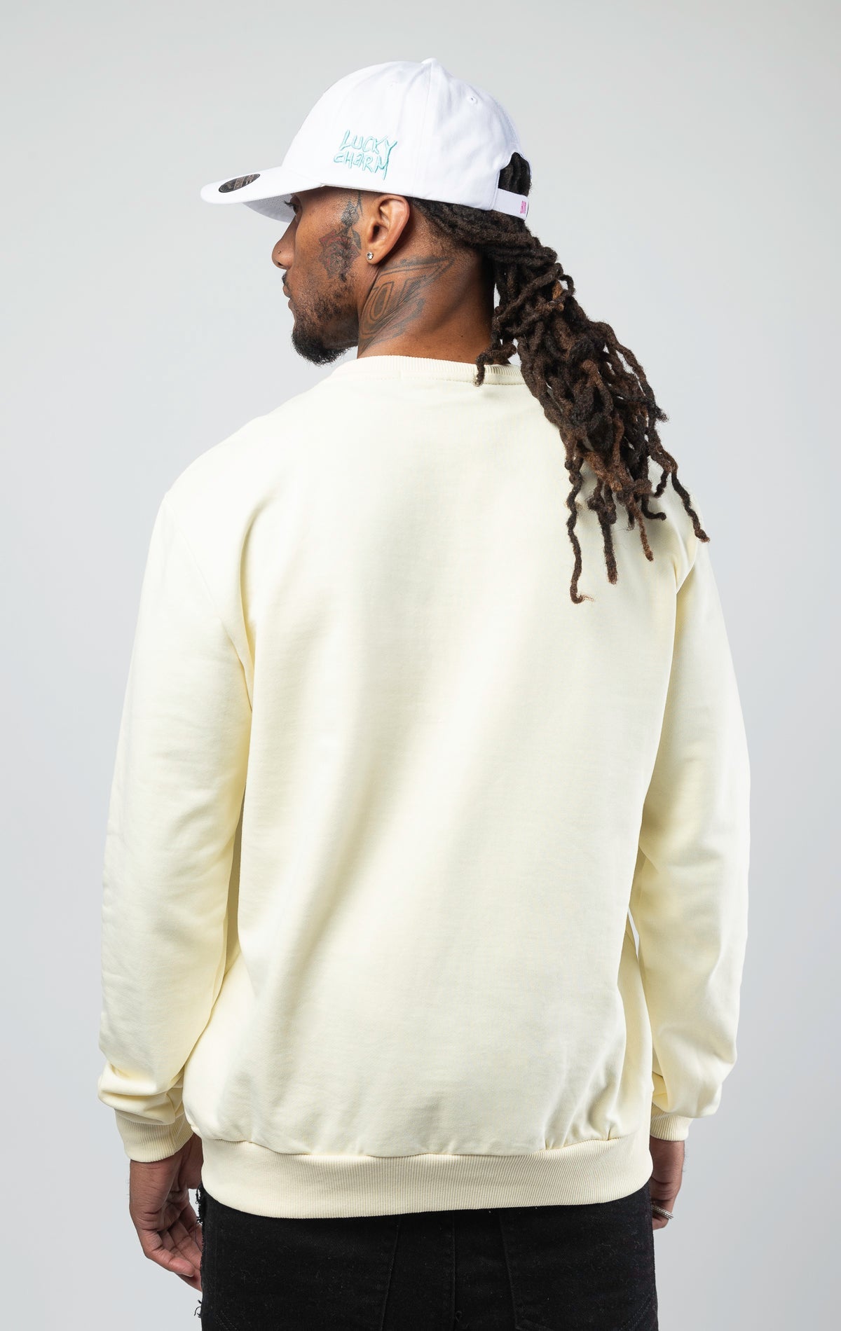 Off white stylish and comfortable sweatshirt featuring a vibrant lucky charm bunny print and an empowering 'Young, Rich, and Lucky' slogan.