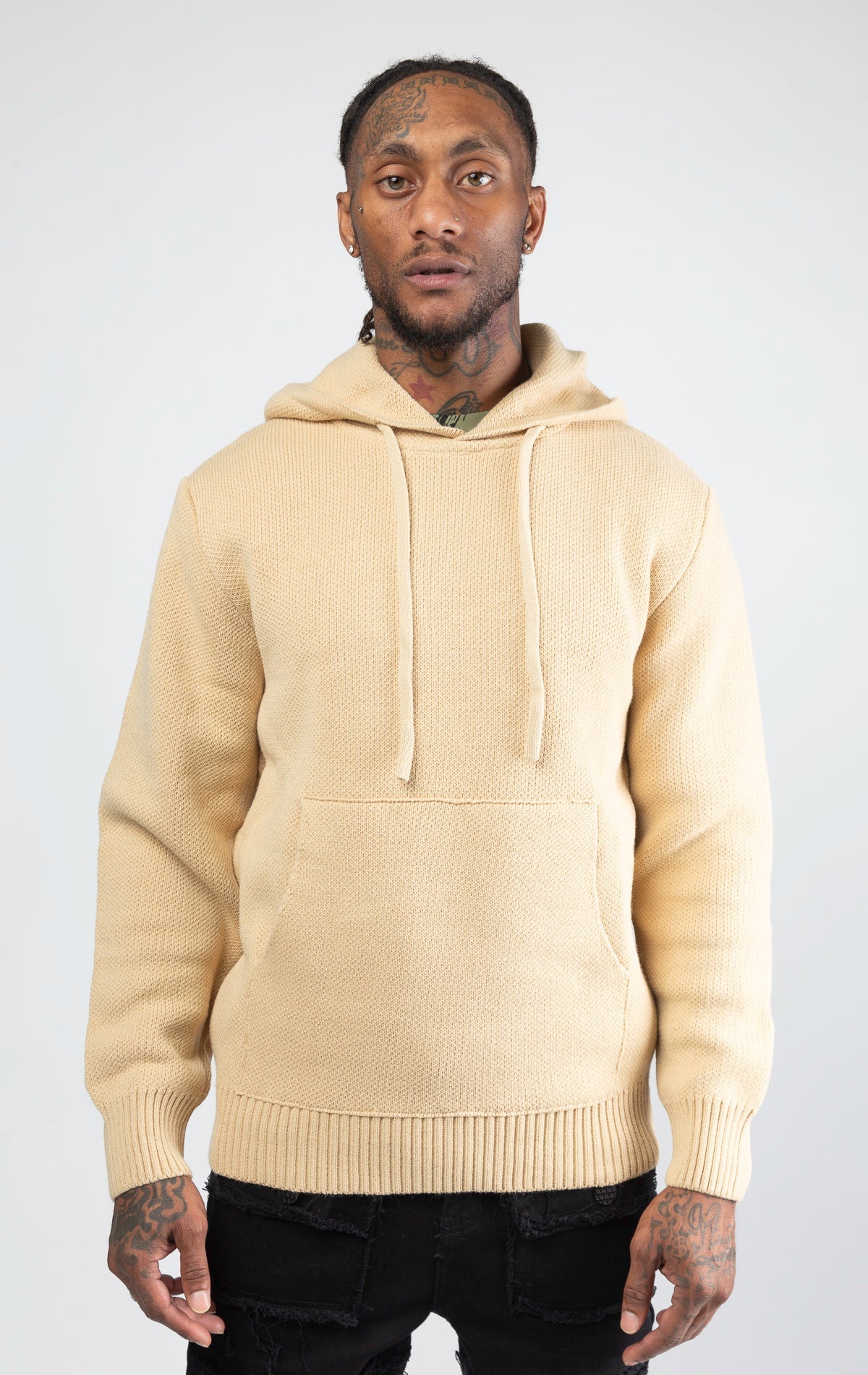 A stylish and comfortable Knitted Jersey Hooded Sweater in sand color, featuring a relaxed fit, a hood, and luxuriously soft knitted jersey fabric.