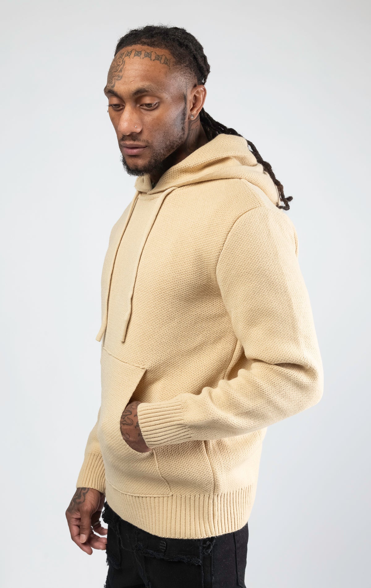 A stylish and comfortable Knitted Jersey Hooded Sweater in sand color, featuring a relaxed fit, a hood, and luxuriously soft knitted jersey fabric.