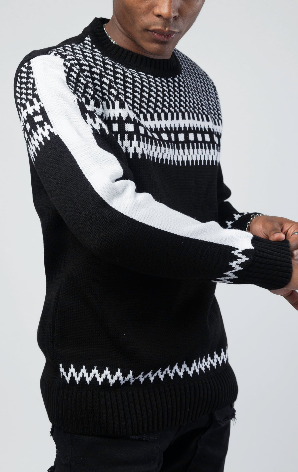A black and white luxurious sweater with classic knit patterns