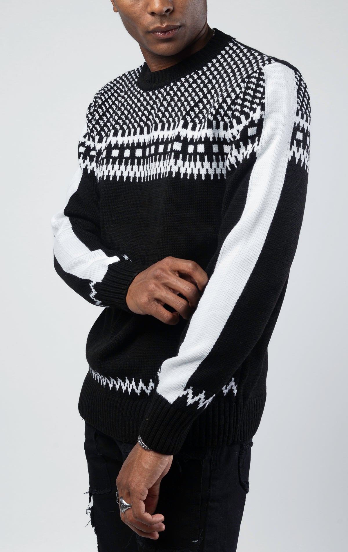A black and white luxurious sweater with classic knit patterns