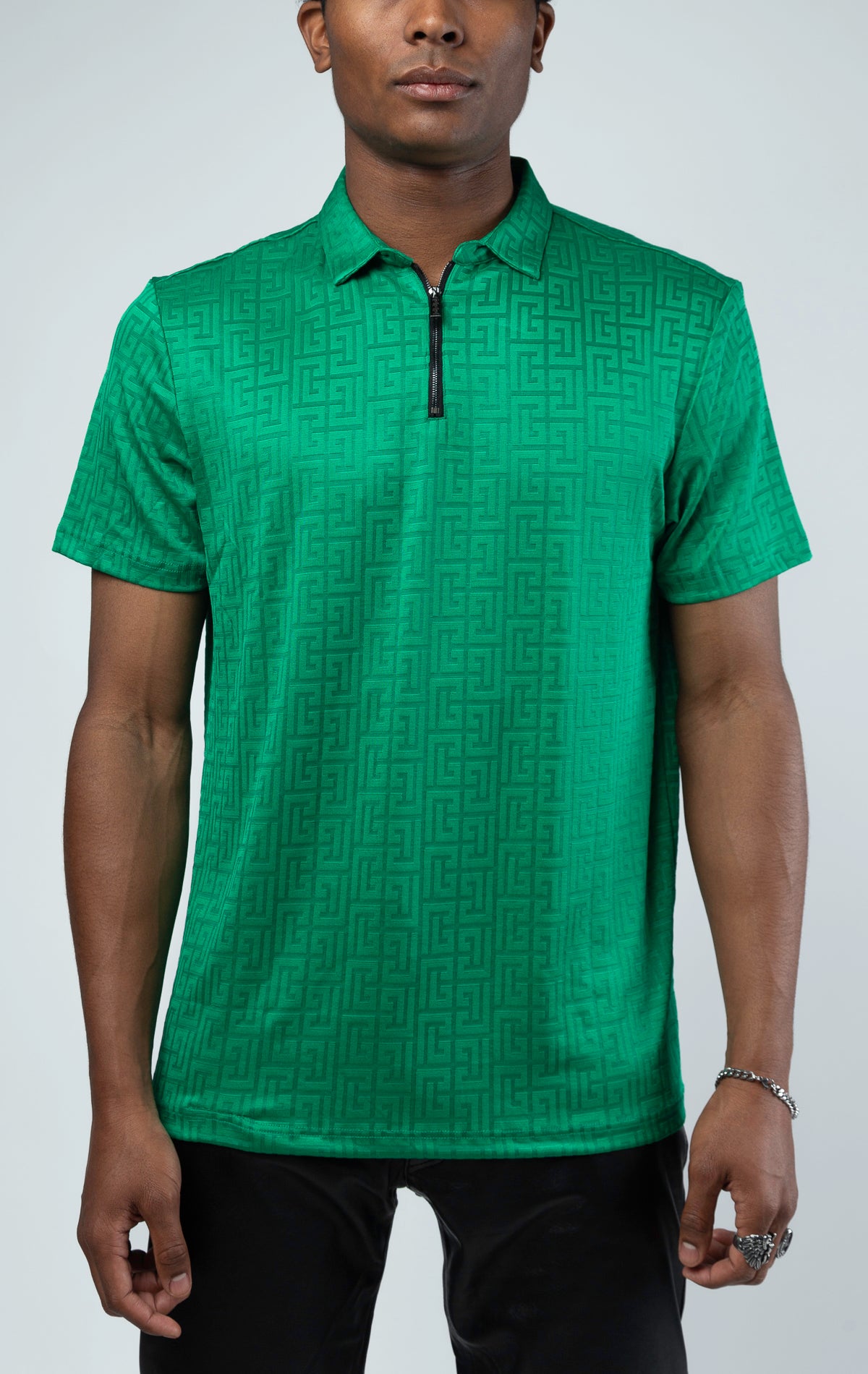 Green This polo shirt is made with Greek key textured fabric. Features a pointed collar, quarter zip-up closure, and short sleeves.