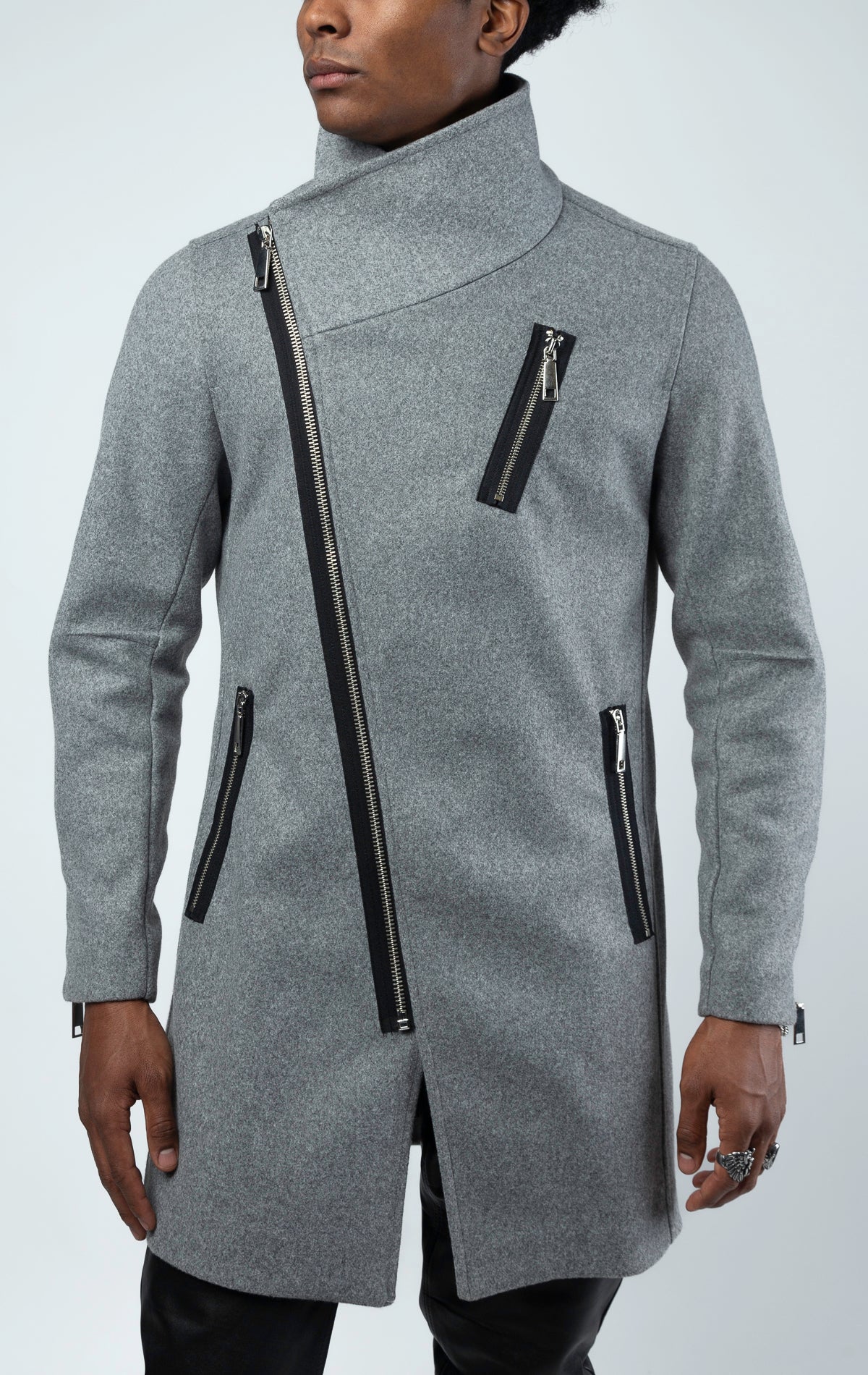 Grey long coat with angled zip closure running diagonally across the front, creating an asymmetrical design.