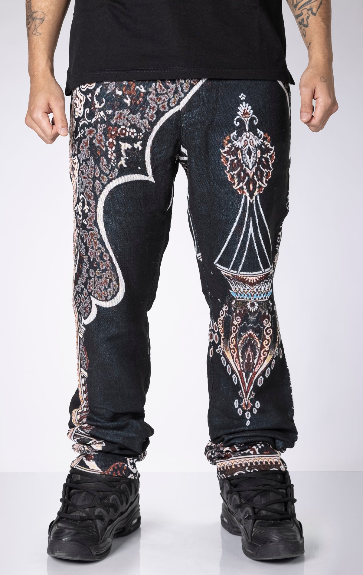 Persian Tapestry Pants. Made from 100% luxury cotton for superior comfort. Features a straight leg fit, allover tapestry print, cargo pockets, fringe accents, and custom hardware.