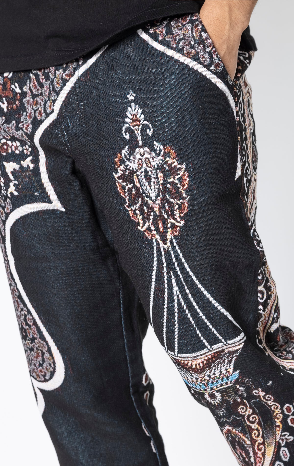 Persian Tapestry Pants. Made from 100% luxury cotton for superior comfort. Features a straight leg fit, allover tapestry print, cargo pockets, fringe accents, and custom hardware.