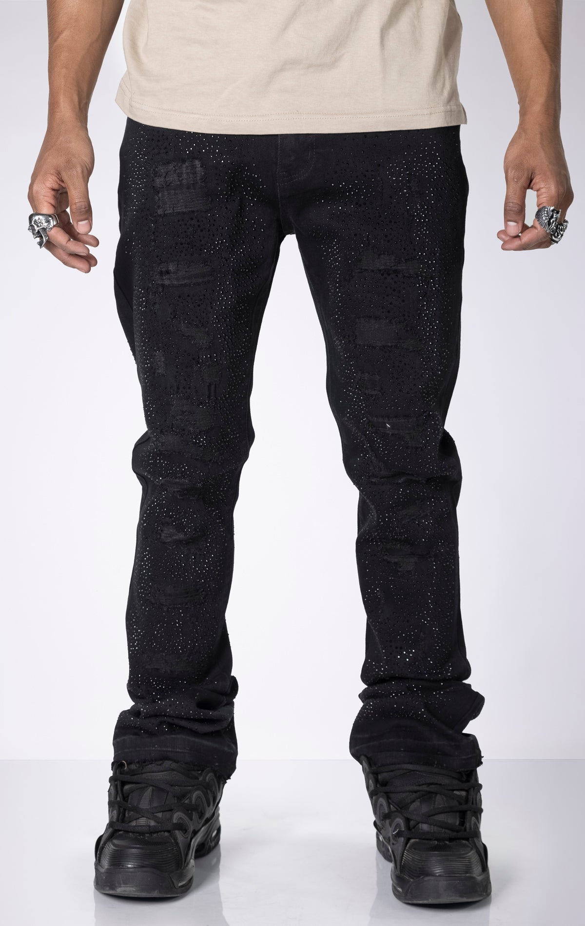 Vintage Wash Stacked Jeans. Features a stacked silhouette, rip repair detailing, and a vintage wash.