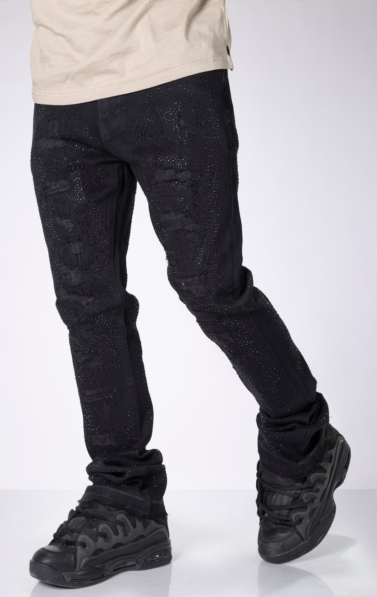 Vintage Wash Stacked Jeans. Features a stacked silhouette, rip repair detailing, and a vintage wash.