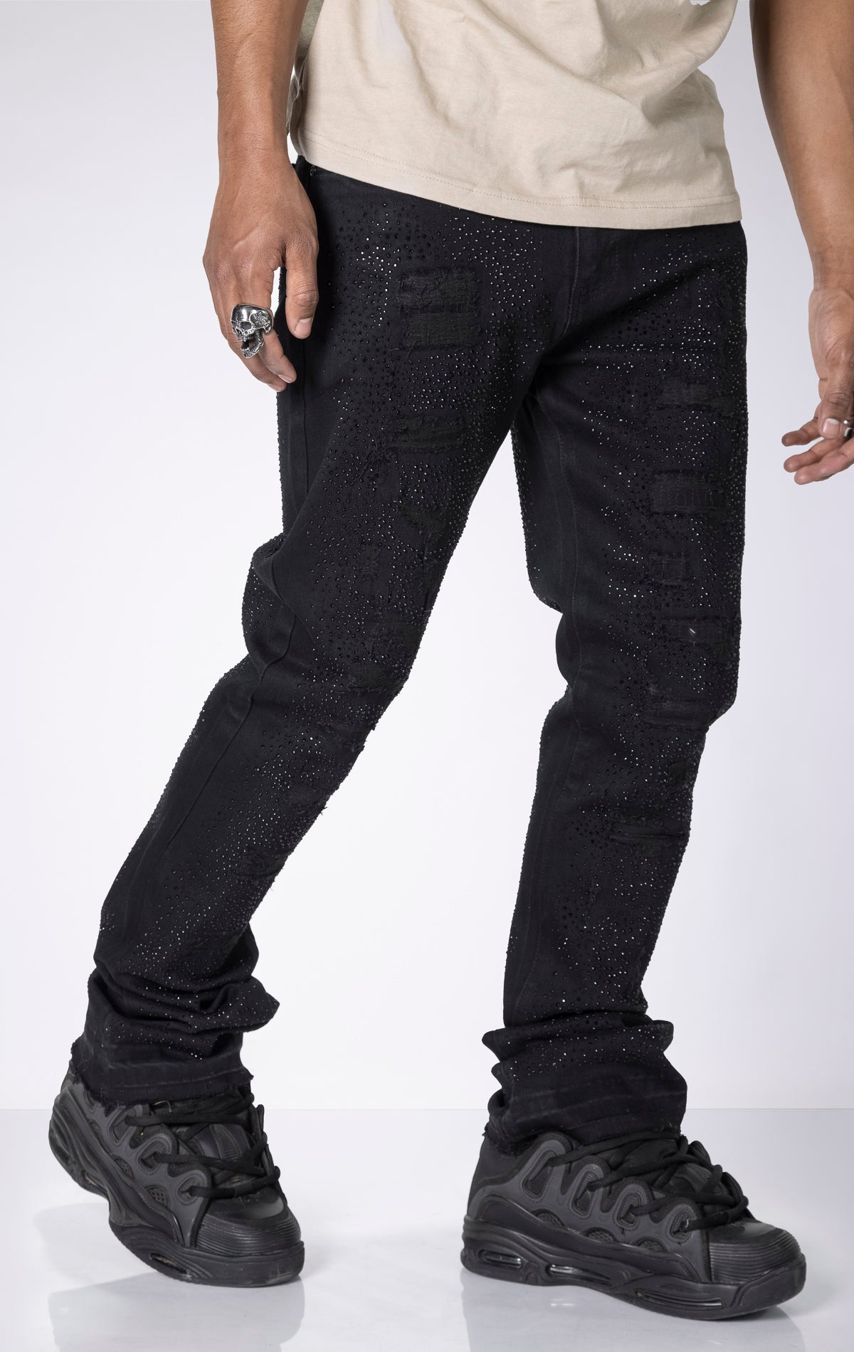 Vintage Wash Stacked Jeans. Features a stacked silhouette, rip repair detailing, and a vintage wash.