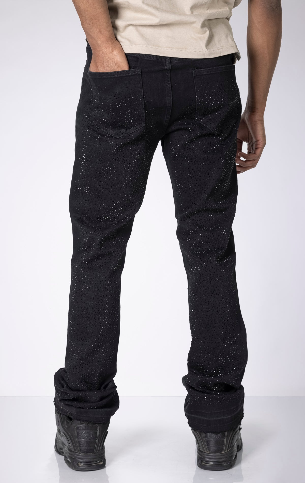 Vintage Wash Stacked Jeans. Features a stacked silhouette, rip repair detailing, and a vintage wash.