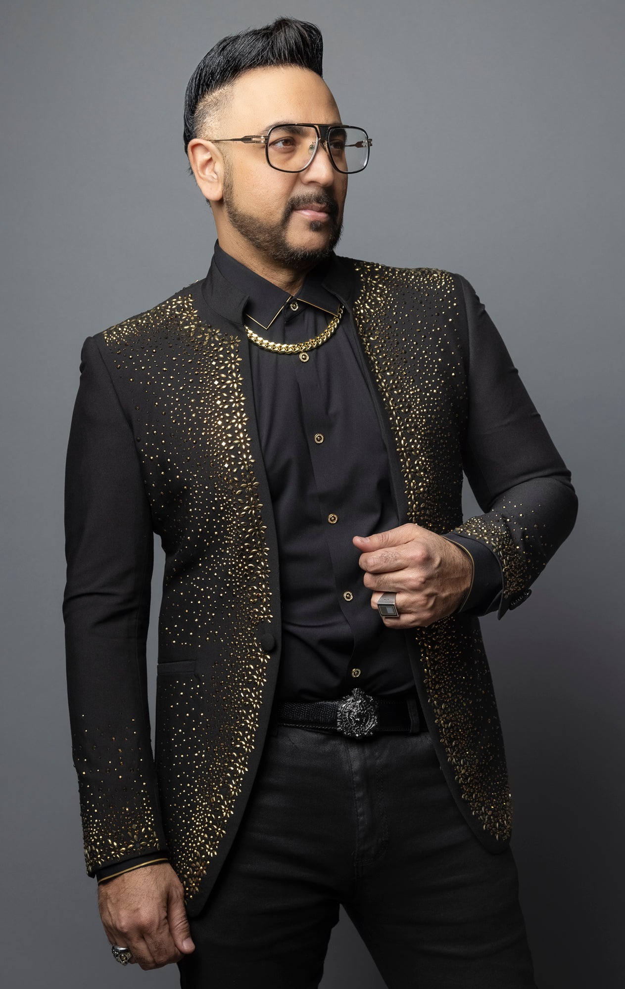 Black blazer featuring a solid color and striking gold rhinestone design, with a band collar