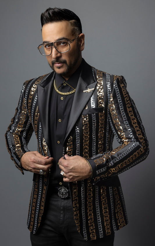Men's slim-fit blazer with a satin notch lapel, long sleeves, and two-button closure. The blazer features a unique pattern combining Cuban chain, Greek key, and sequin designs. Made from 100% regenerated fiber.