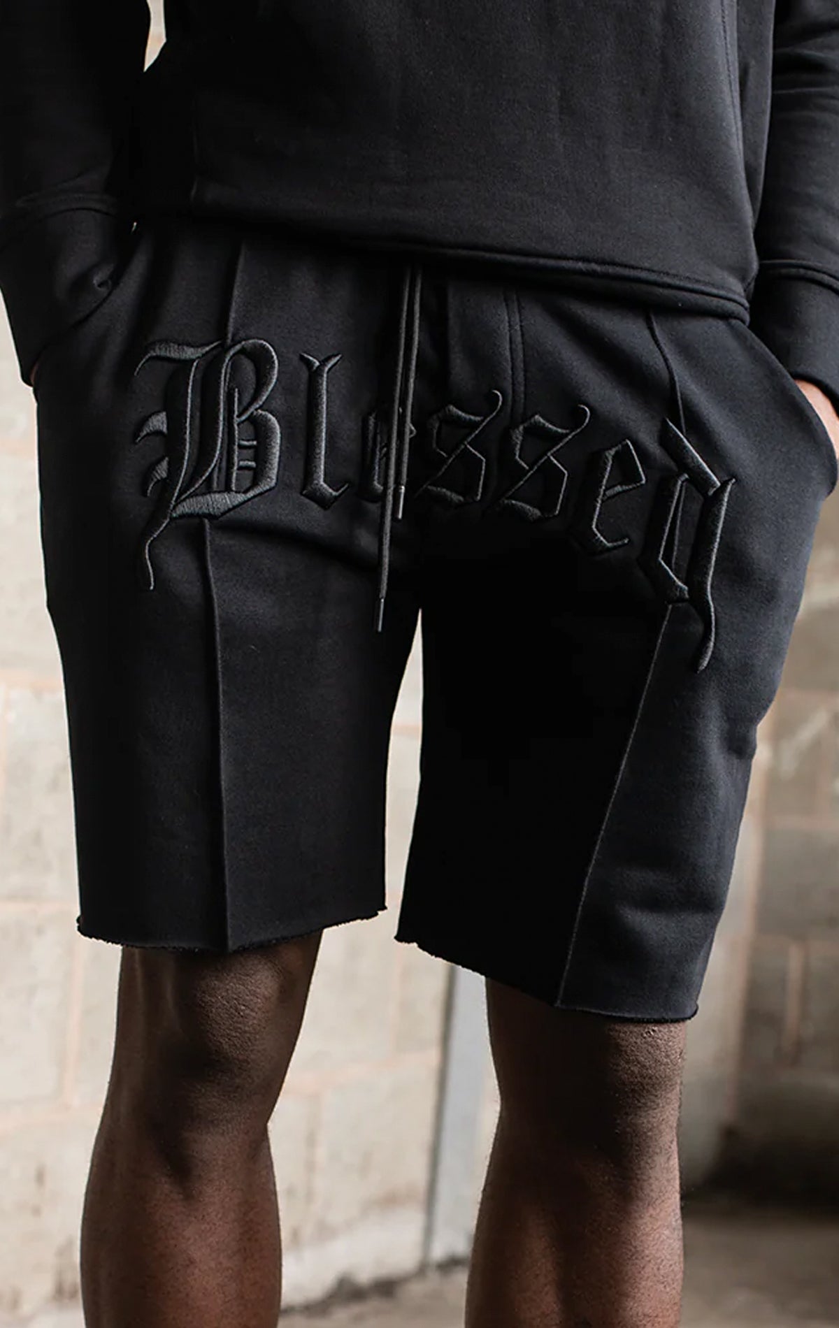 Men's casual, straight-leg shorts in black. The shorts feature a 100% cotton fabric, an arched 3D embroidered 
