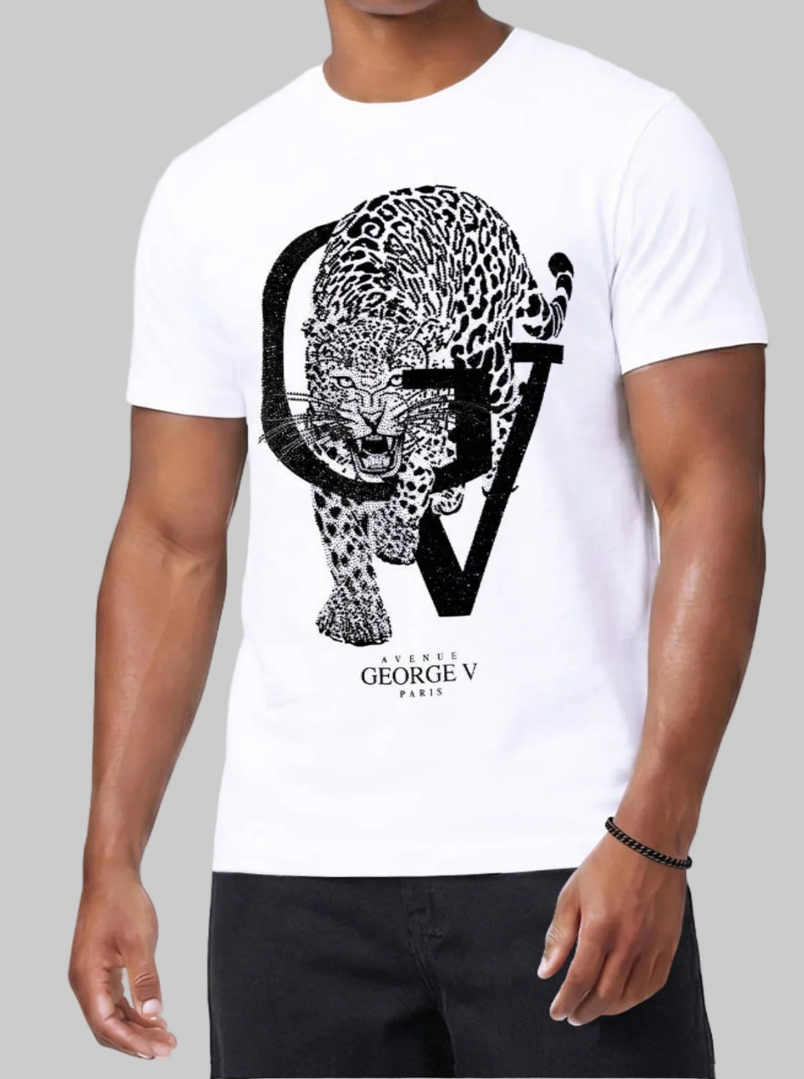 A man wearing a white short-sleeve t-shirt with a large black graphic print of a leopard and the letters G and V, with 'GEORGE V PARIS' printed below. The model is also wearing black pants against a clean white background.
