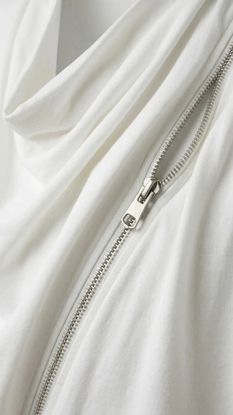 Close-up of a white garment with a zipper detail