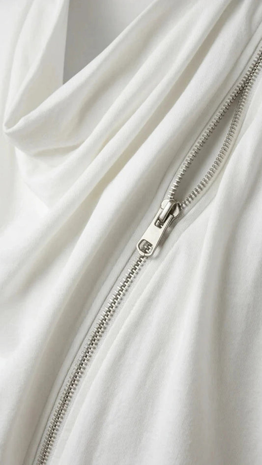 Close-up of a white garment with a zipper detail