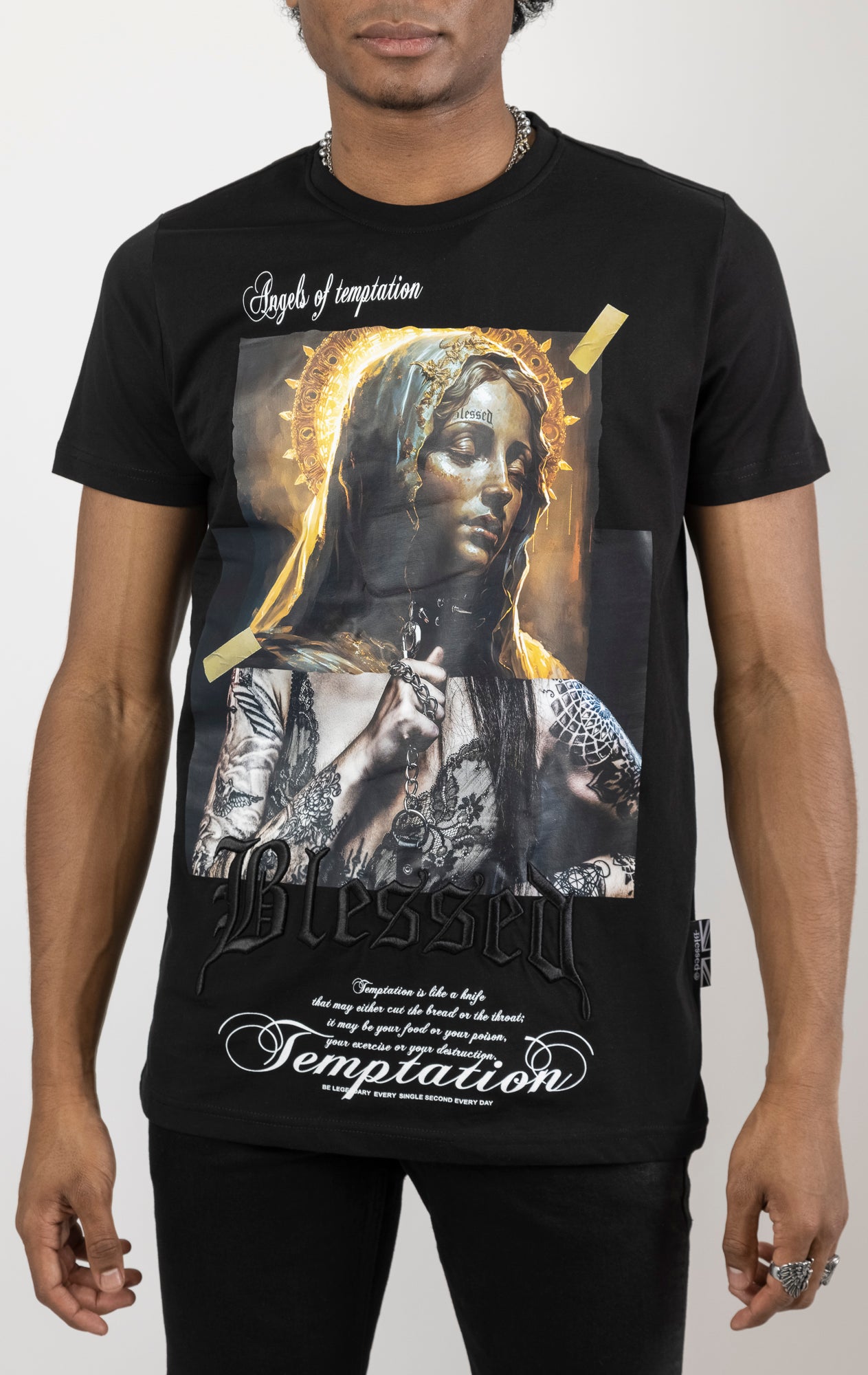 Black Men's regular fit t-shirt in a variety of colors. The shirt features a slightly elongated sleeve, a fitted neckline, and a straight body. It has a "Temptation" front print with 3D embroidery.  Made from 100% cotton jersey (190gsm).  A "blessed" slogan is printed on the inner neck binding and a woven side seam tab with "blessed" is also included.