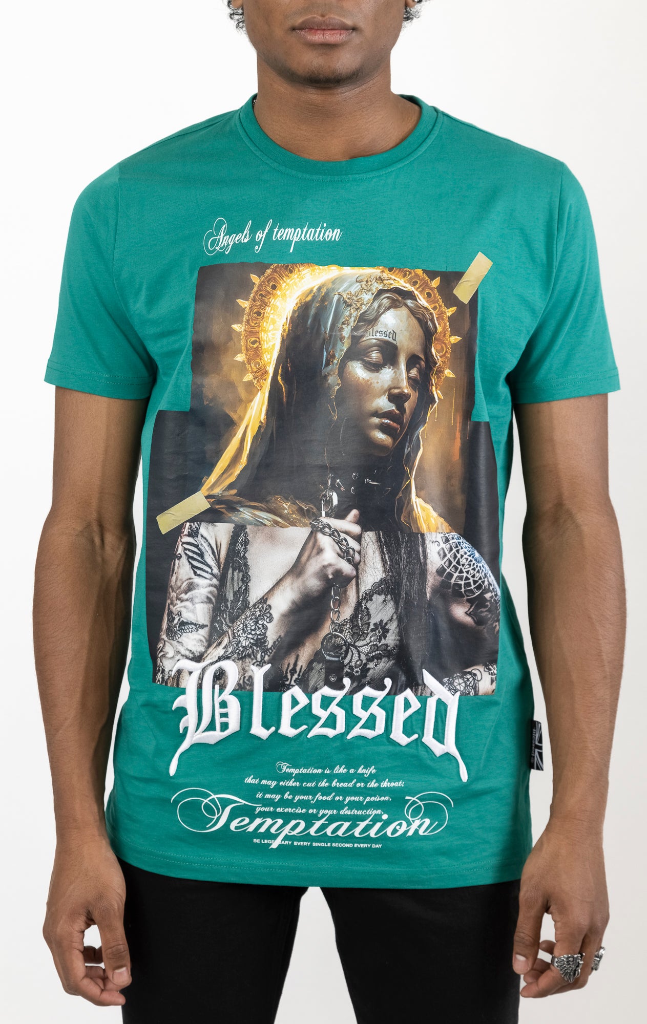 Lagoon Men's regular fit t-shirt in a variety of colors. The shirt features a slightly elongated sleeve, a fitted neckline, and a straight body. It has a "Temptation" front print with 3D embroidery. Made from 100% cotton jersey (190gsm). A "blessed" slogan is printed on the inner neck binding and a woven side seam tab with "blessed" is also included.