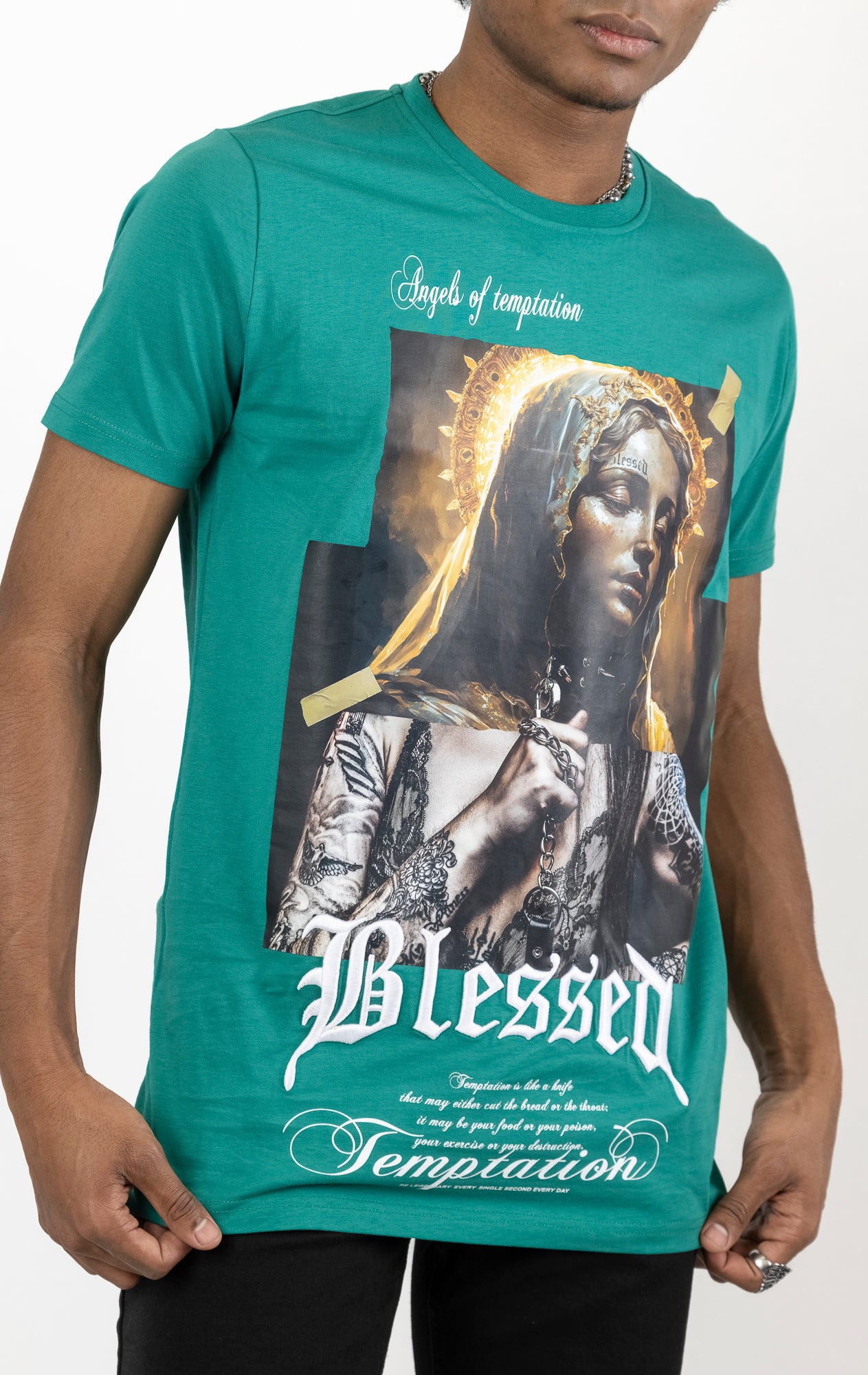 Lagoon Men's regular fit t-shirt in a variety of colors. The shirt features a slightly elongated sleeve, a fitted neckline, and a straight body. It has a "Temptation" front print with 3D embroidery. Made from 100% cotton jersey (190gsm). A "blessed" slogan is printed on the inner neck binding and a woven side seam tab with "blessed" is also included.