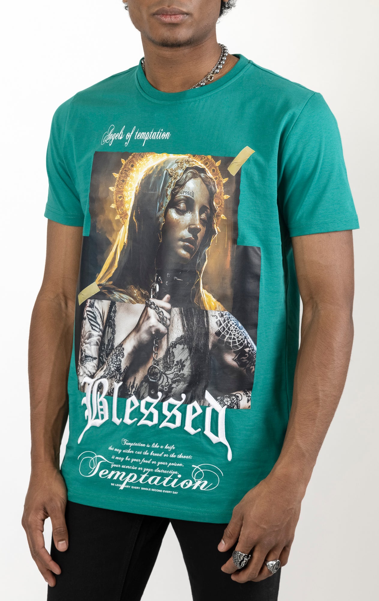 Lagoon Men's regular fit t-shirt in a variety of colors. The shirt features a slightly elongated sleeve, a fitted neckline, and a straight body. It has a "Temptation" front print with 3D embroidery. Made from 100% cotton jersey (190gsm). A "blessed" slogan is printed on the inner neck binding and a woven side seam tab with "blessed" is also included.