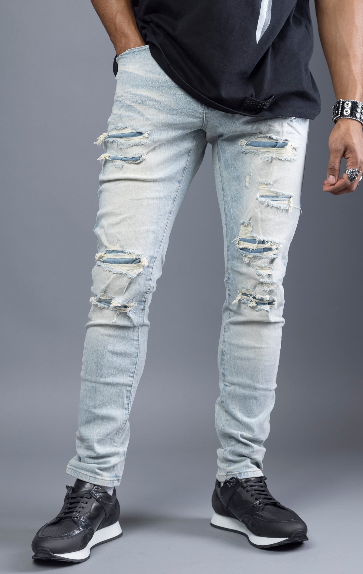 Light blue, slim-fit denim jeans with ripped and repaired patches throughout. Made with stretchy denim fabric for a comfortable fit. (98% cotton, 2% elastane)