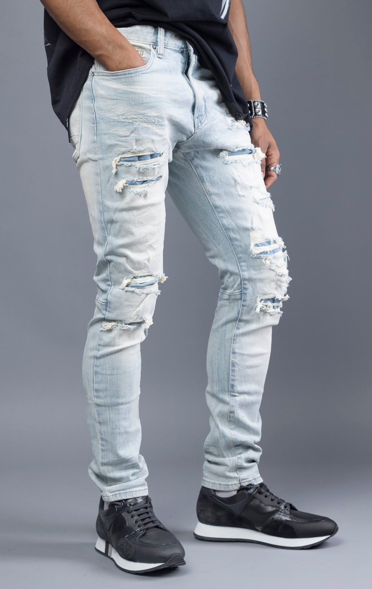 Light blue, slim-fit denim jeans with ripped and repaired patches throughout. Made with stretchy denim fabric for a comfortable fit. (98% cotton, 2% elastane)