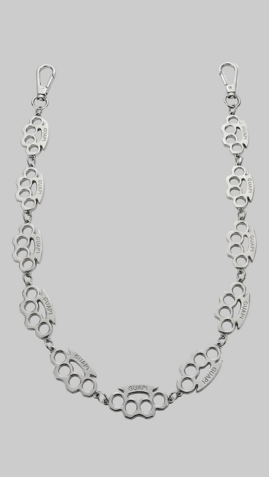 A silver-toned metal chain bracelet featuring repeating knuckle-butt link motifs with engraved text, displayed on a clean white background.