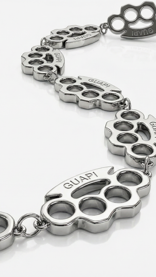 Silver bracelet with knuckle design charms on a white background