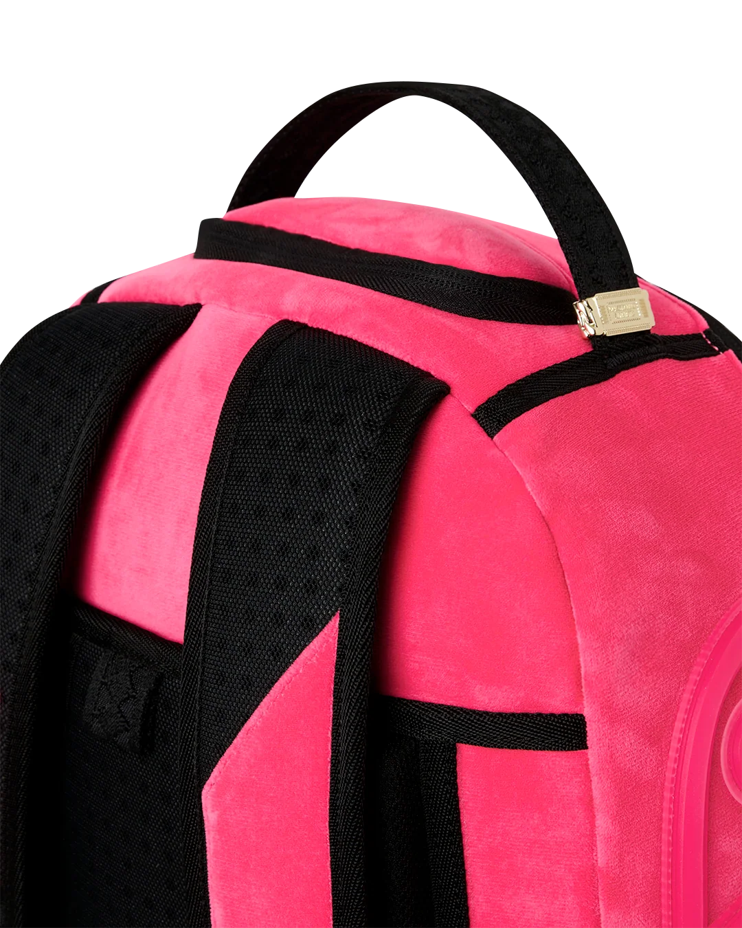 Close-up of a bright pink backpack with black straps, trim, and mesh padding, showing the top handle and zipper area on a white background.