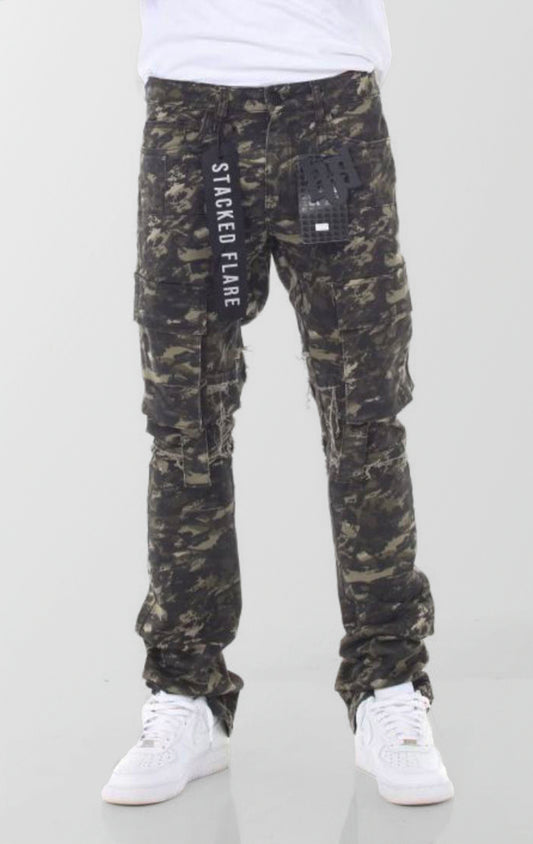 A pair of forest camouflage denim jeans featuring a slim fit that flares and stacks at the ankles, with distressed knees and multiple cargo pockets.