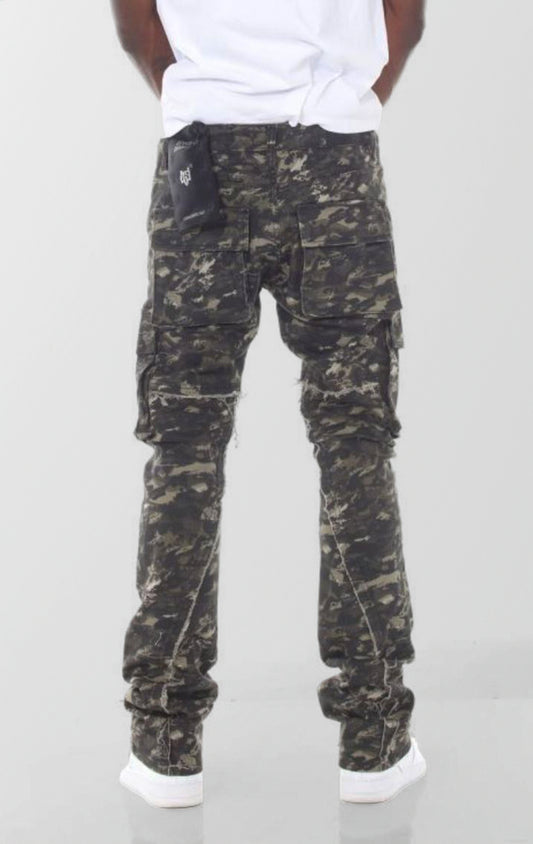 A pair of forest camouflage denim jeans featuring a slim fit that flares and stacks at the ankles, with distressed knees and multiple cargo pockets.